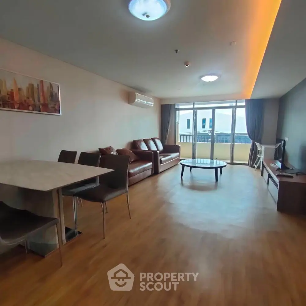 Modern living room with stylish furniture and large windows