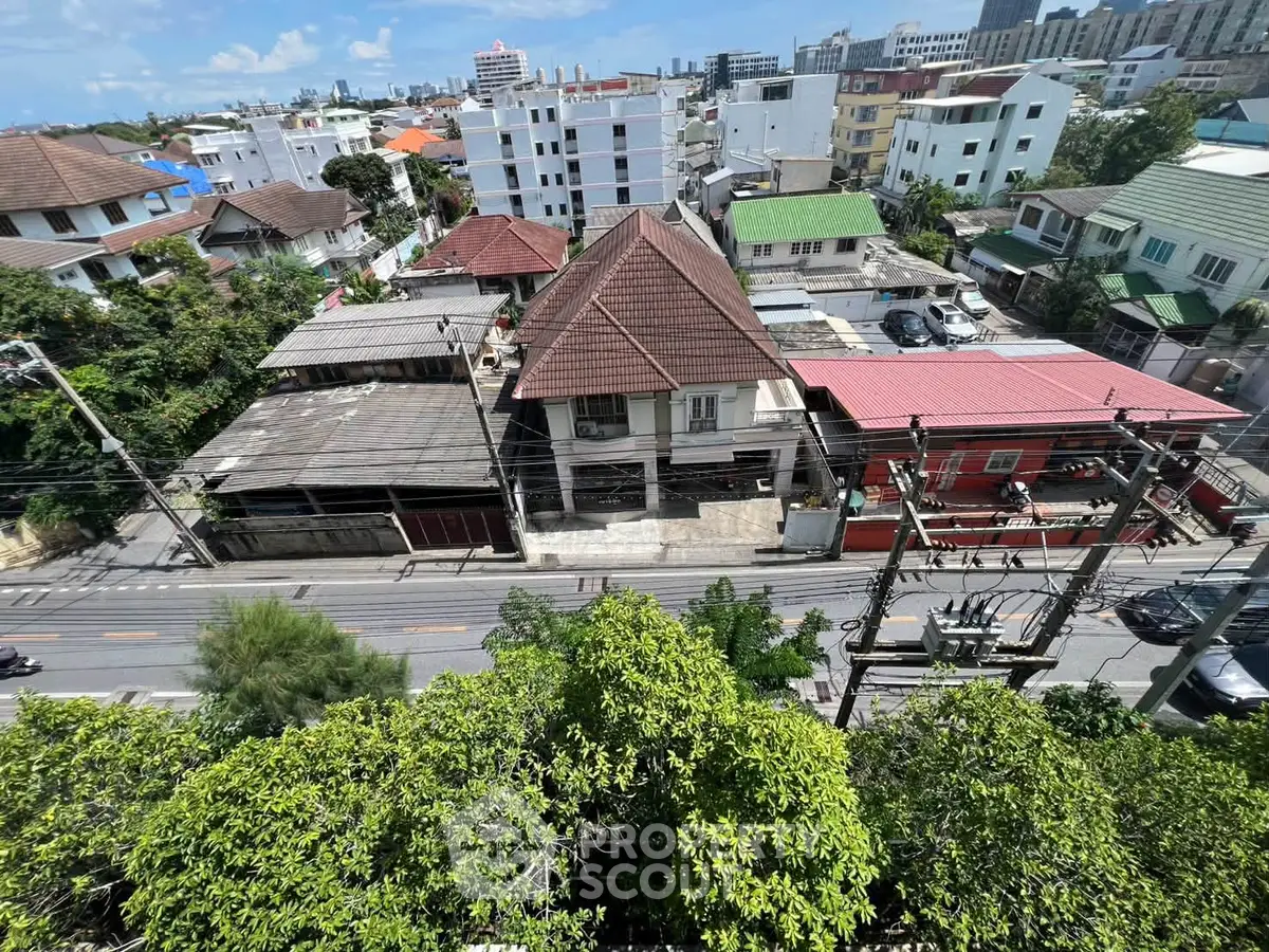 Aerial view of urban residential area with diverse architecture and lush greenery.
