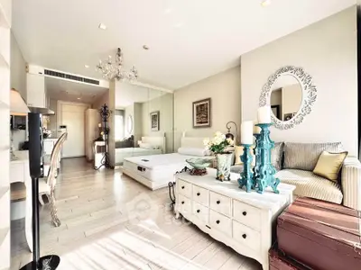 Luxurious living room with elegant decor and ample natural light in a modern apartment.