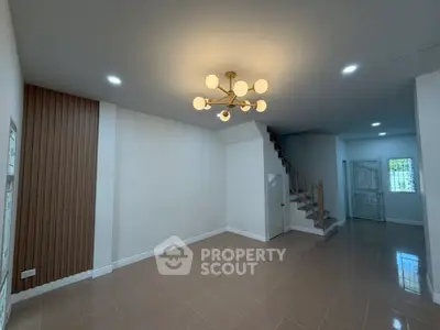 Spacious modern living room with elegant lighting and staircase