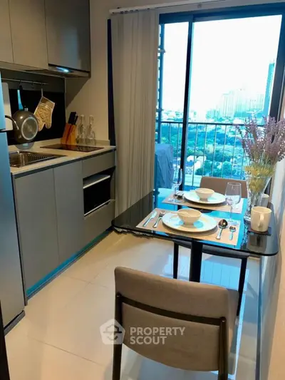 Modern kitchen with dining area and city view from balcony
