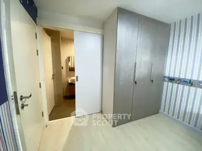 Modern bedroom with sliding door and built-in wardrobe