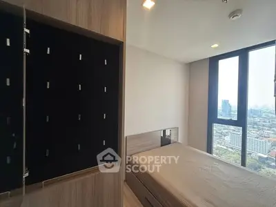 Modern bedroom with city view and built-in wardrobe