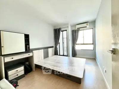 Spacious bedroom with modern furnishings and natural light