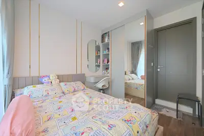Charming bedroom with modern decor and ample storage in a cozy apartment.