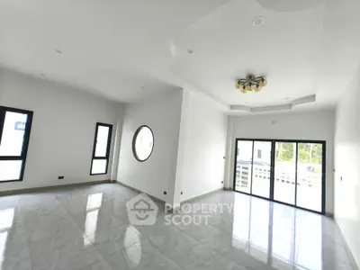 Spacious modern living room with large windows and elegant ceiling design