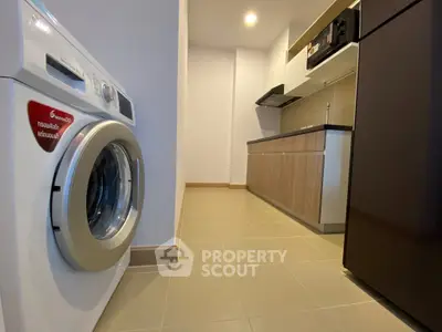 Modern kitchen with washing machine and sleek cabinetry