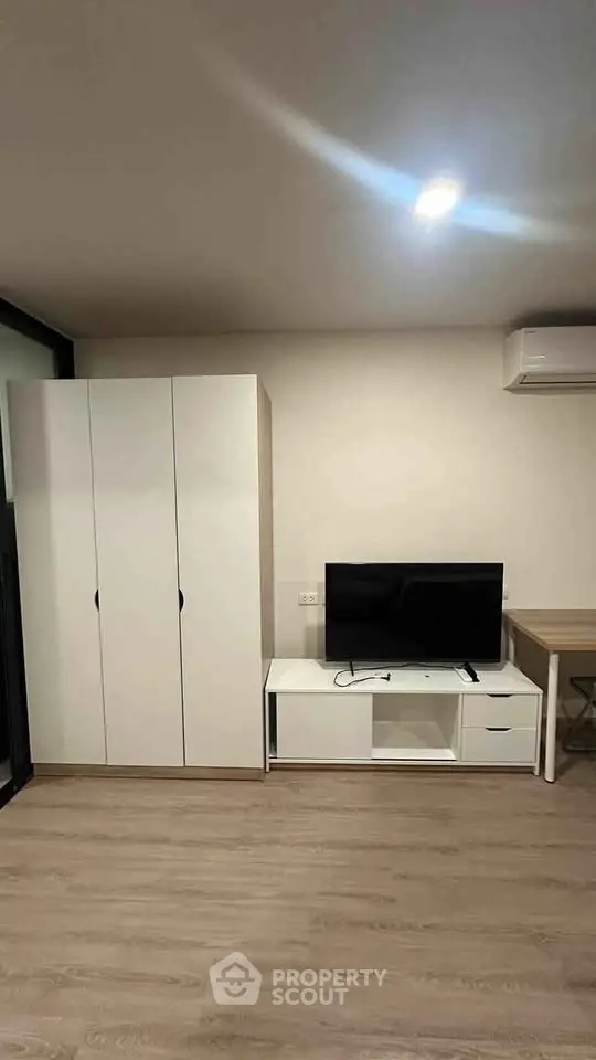 Modern living room with sleek furniture and air conditioning unit, perfect for comfortable living.