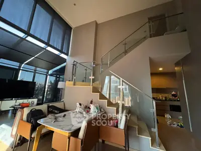 Luxurious modern living room with high ceilings and stylish staircase