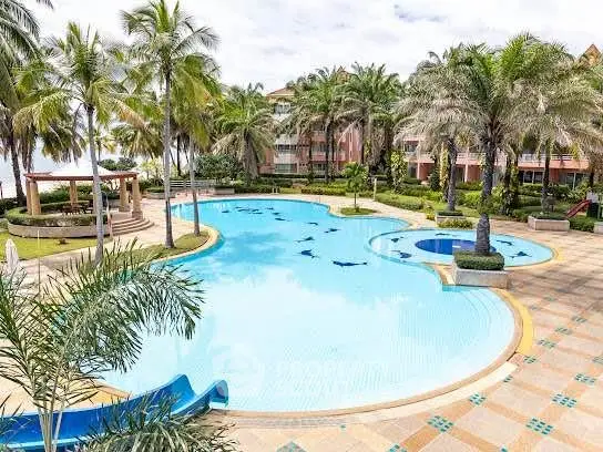 Luxurious resort-style pool area with lush landscaping and palm trees, perfect for relaxation and leisure.