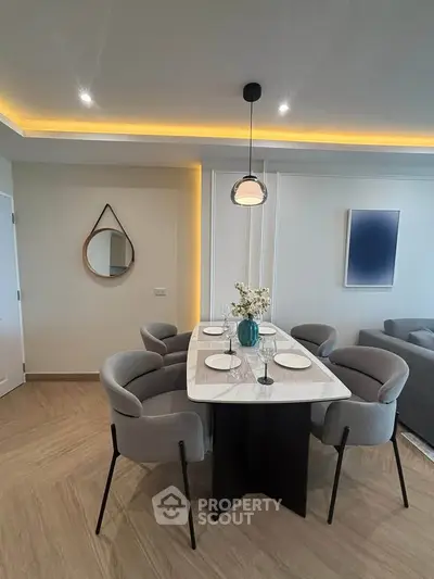 Modern dining area with elegant table and stylish chairs in a contemporary apartment.