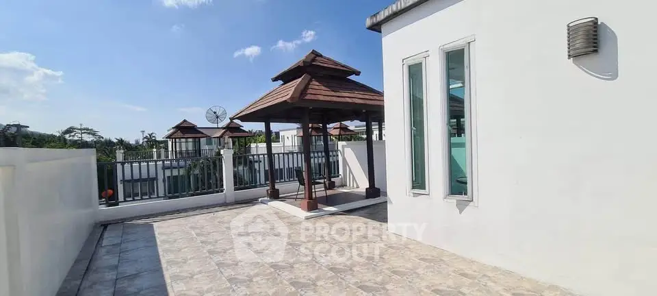 Spacious rooftop terrace with gazebo and scenic views, perfect for relaxation and entertainment.