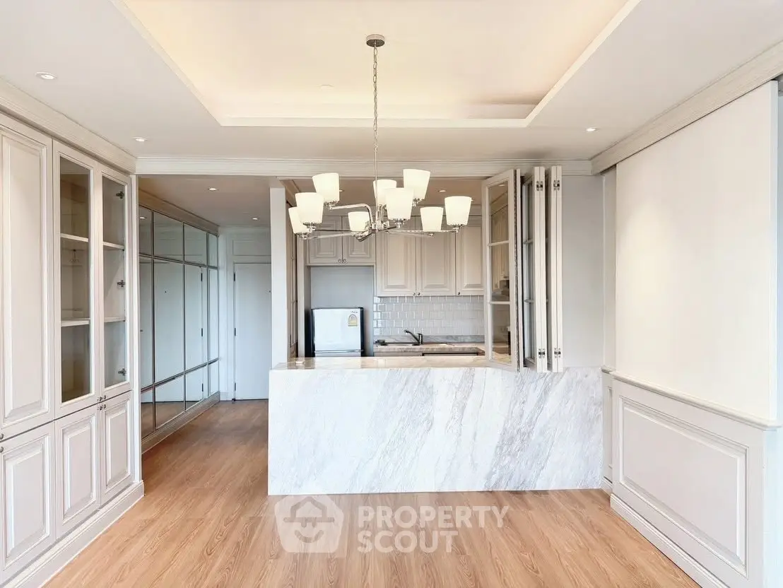 Elegant kitchen with marble island and modern chandelier lighting