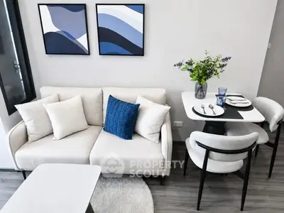 Modern living room with stylish decor and dining area, featuring a cozy sofa and elegant table setting.