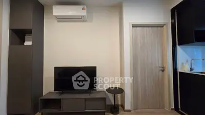Modern living room with sleek furniture and air conditioning unit, perfect for comfortable living.