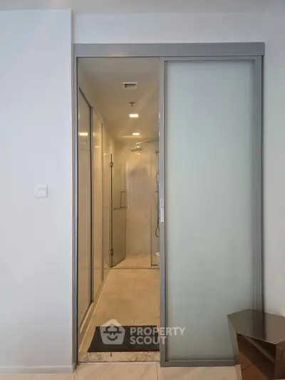 Modern bathroom with sliding glass door and sleek design