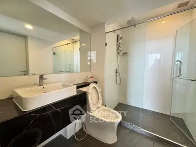 Modern bathroom with sleek design, glass shower enclosure, and elegant fixtures.