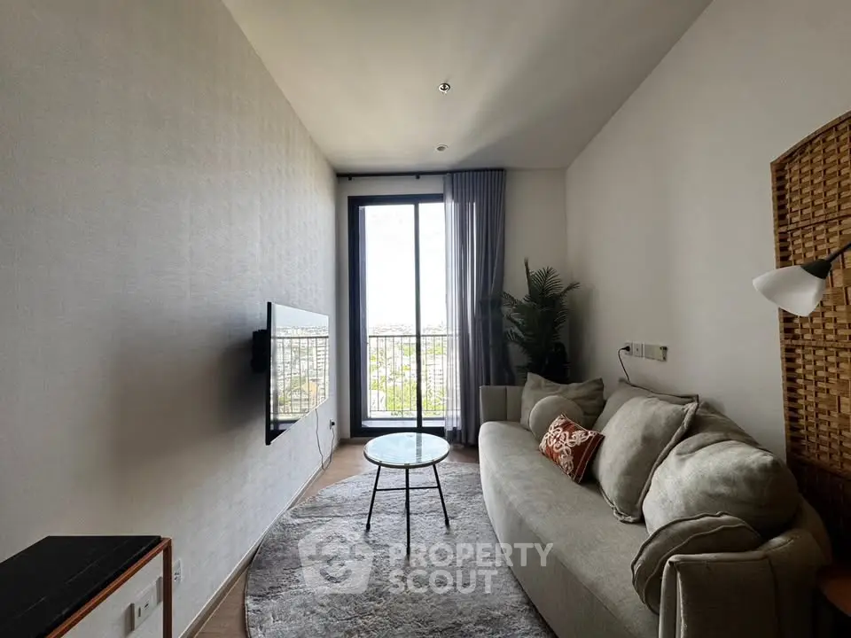Stylish modern living room with cozy sofa and large window offering natural light and city views.