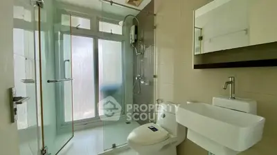 Modern bathroom with glass shower and sleek fixtures