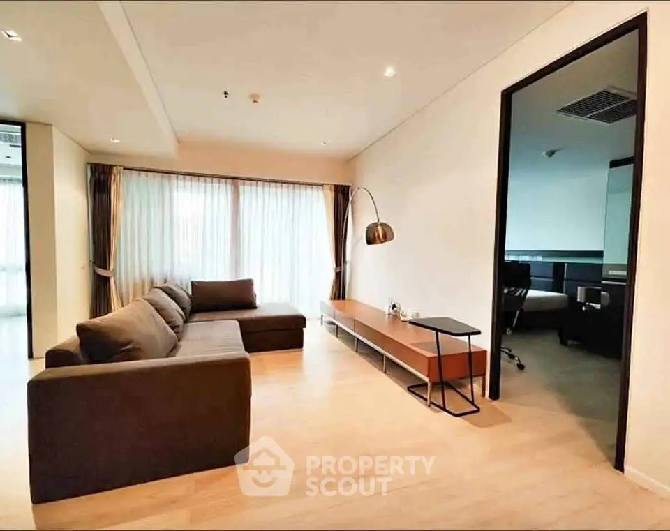 Spacious modern living room with elegant decor and large windows for natural light.