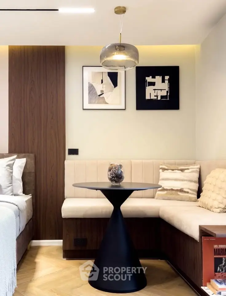 Stylish modern bedroom corner with cozy seating and elegant decor