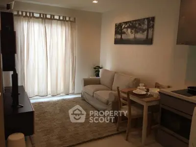 Cozy living room with natural light and modern decor in a stylish apartment.