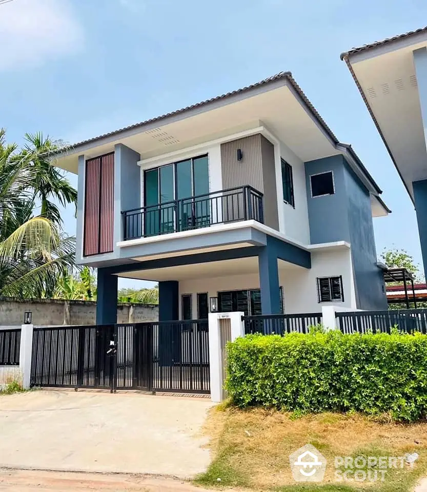 Modern two-story house with sleek design and spacious balcony in a serene neighborhood.