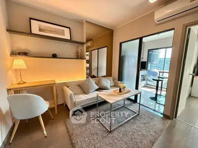 Modern living room with cozy seating and stylish decor in a contemporary apartment.