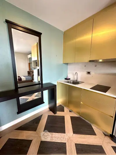 Modern kitchen with gold cabinets and sleek design