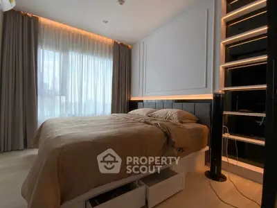 Luxurious bedroom with modern lighting and large window for natural light.