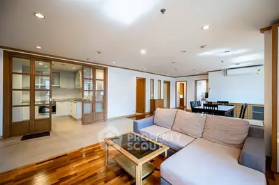 Spacious open-plan living room with modern kitchen and dining area.