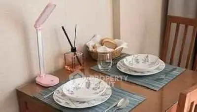 Charming dining setup with elegant tableware and cozy ambiance, perfect for intimate meals.
