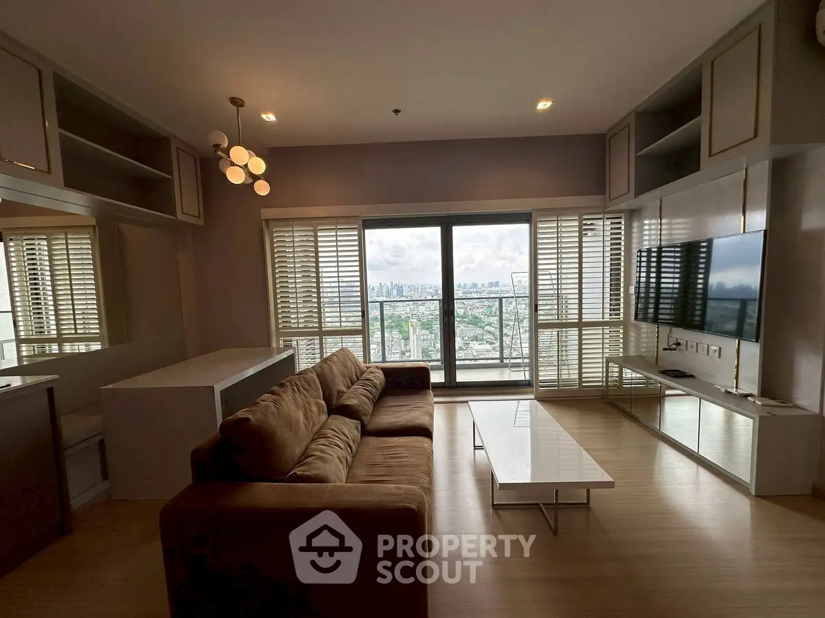 Spacious living room with stunning city view, modern furnishings, and ample natural light.