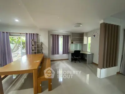 Spacious modern living room with large windows and sleek furniture