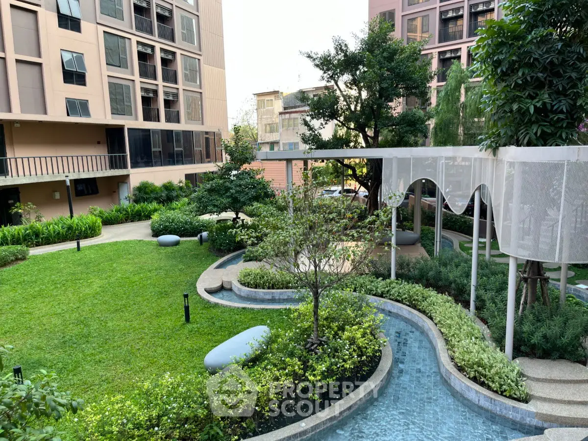 Beautiful garden view with lush greenery and modern architecture in a residential complex.