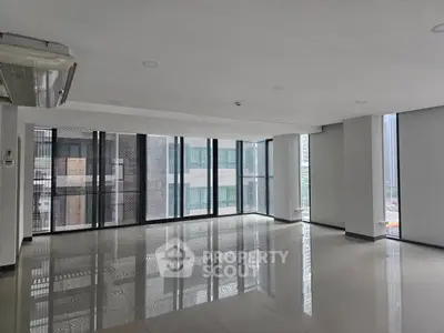 Spacious modern living room with large windows and city view