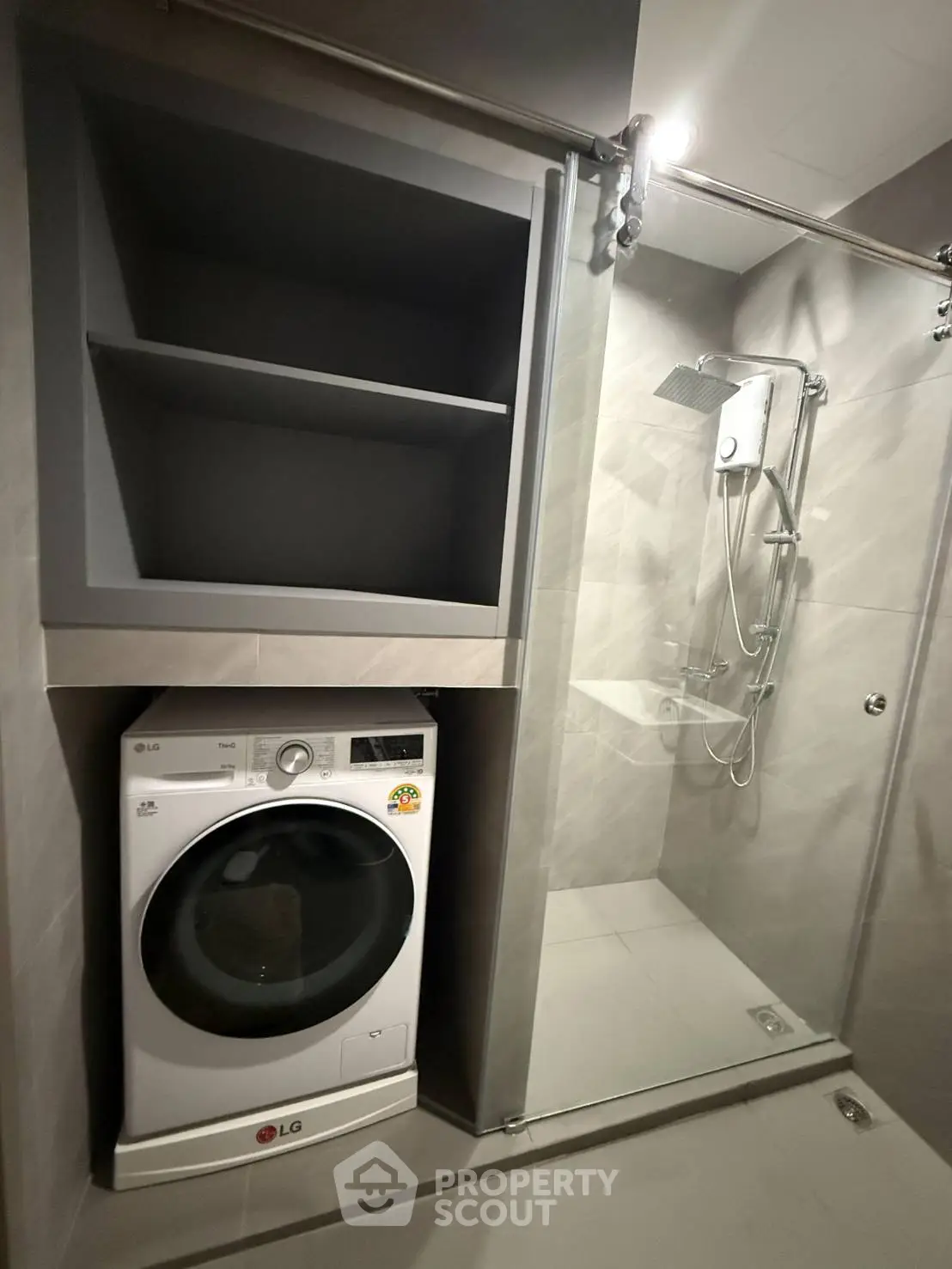 Modern bathroom with shower and built-in washing machine