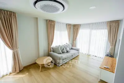 Bright and airy living room with large windows and elegant curtains