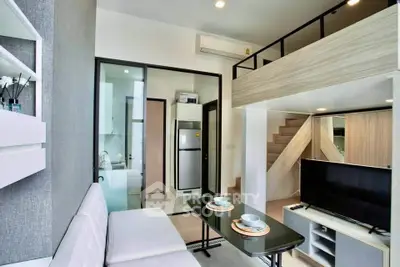 Modern loft-style living room with mezzanine, sleek furniture, and open kitchen layout.