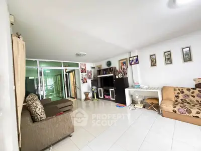 Spacious living room with modern decor and ample natural light, perfect for family gatherings.