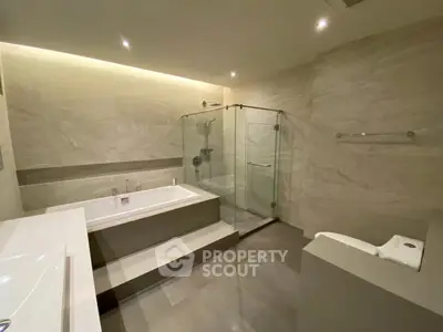 Luxurious modern bathroom with elegant bathtub and glass shower enclosure