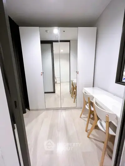 Modern study room with mirrored wardrobe and sleek white desk