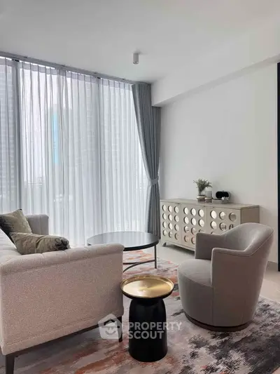 Modern living room with stylish furniture and floor-to-ceiling windows