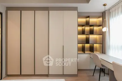 Modern bedroom with built-in wardrobe and stylish study area