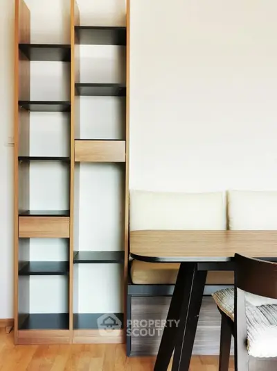 Modern interior with sleek shelving and cozy dining area, perfect for stylish urban living.