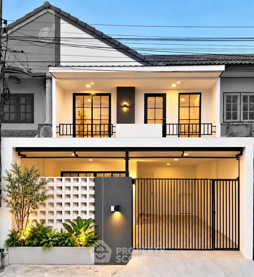 Modern two-story townhouse with elegant facade and gated entrance