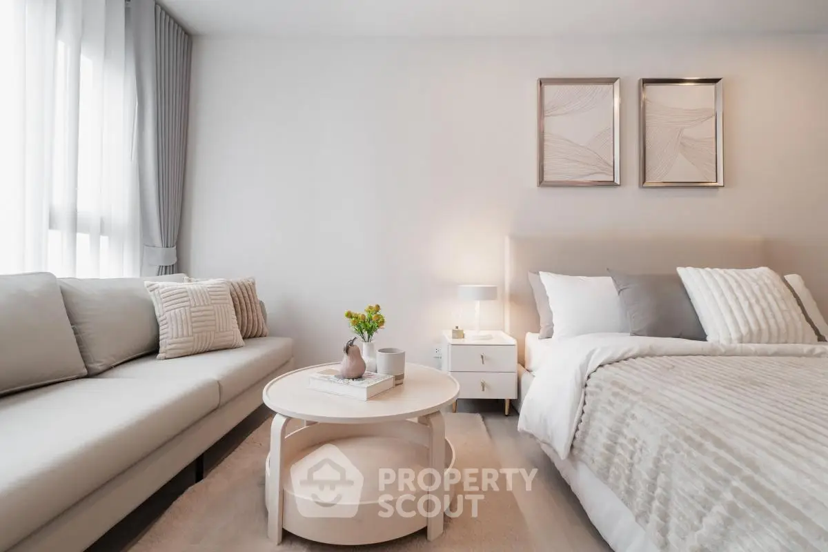 Elegant bedroom with cozy sofa and stylish decor in modern apartment.