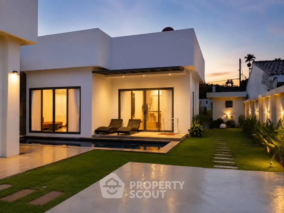 Modern luxury villa with pool and garden at sunset, showcasing sleek architecture and serene ambiance.