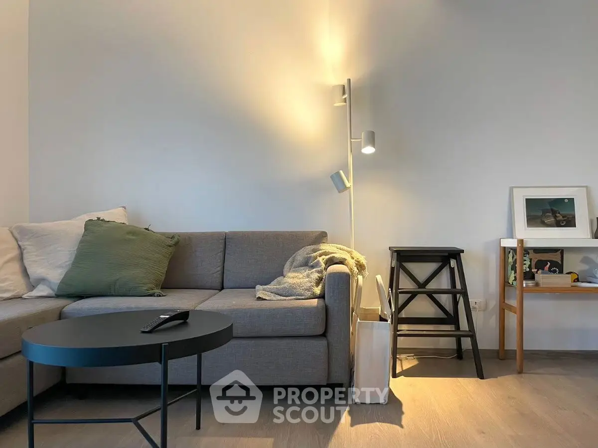 Cozy living room with modern gray sofa and stylish floor lamp