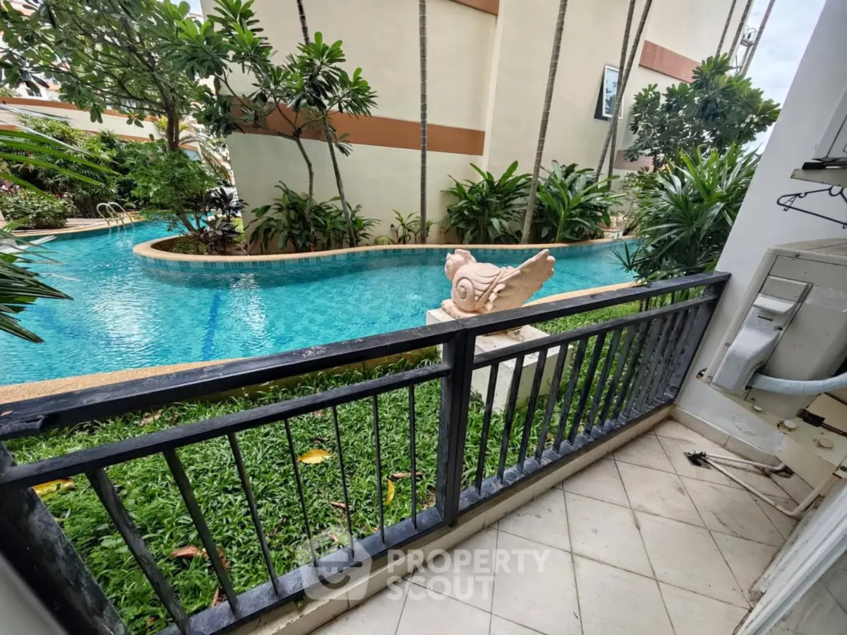 Charming balcony with pool view in tropical setting, perfect for relaxation and leisure.
